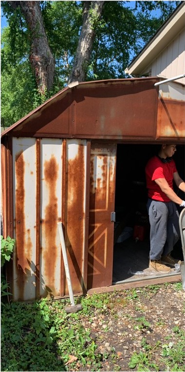 Rusted metal shed before removal
